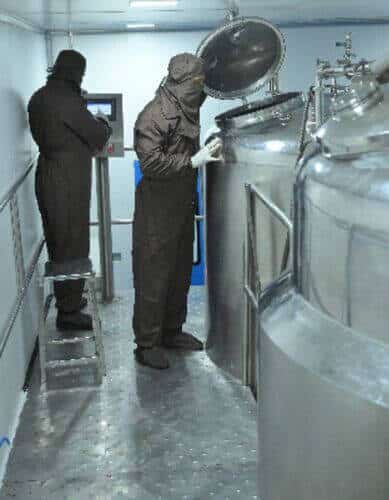Operator at a stainless steel manufacturing vessel