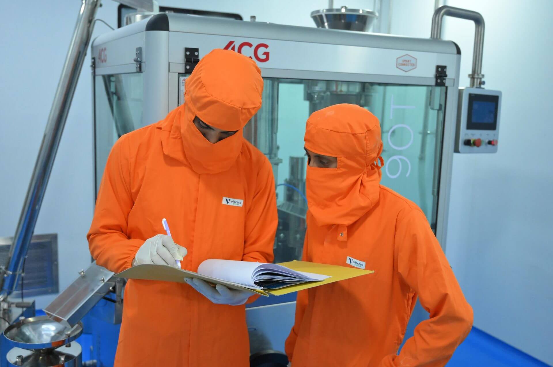Operators at the ACG AF90T capsule filling machine, Vibcare Healthcare plant