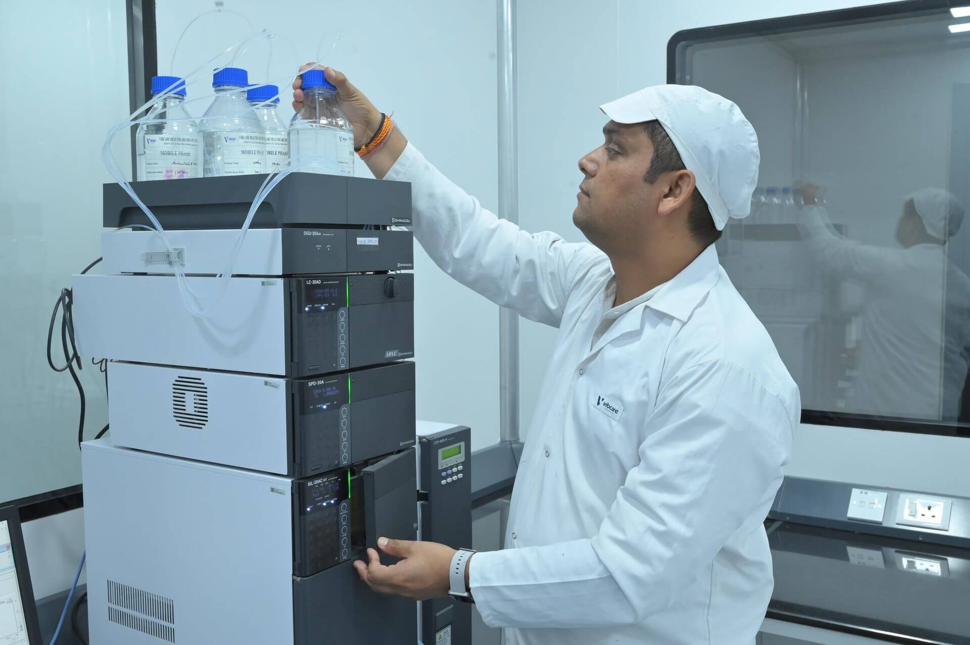 Analyst setting up mobile phase on the HPLC in the quality control laboratory at Vibcare Healthcare, Panchkula