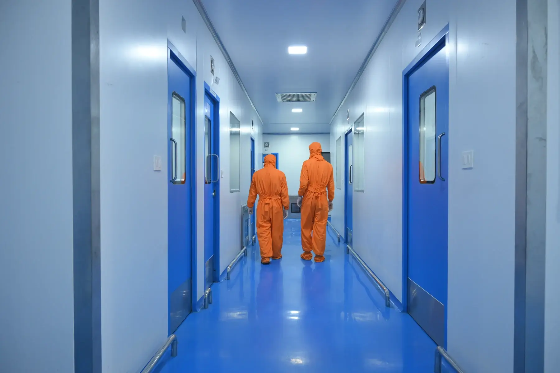 Production staff in the clean room corridor at the Vibcare Healthcare plant